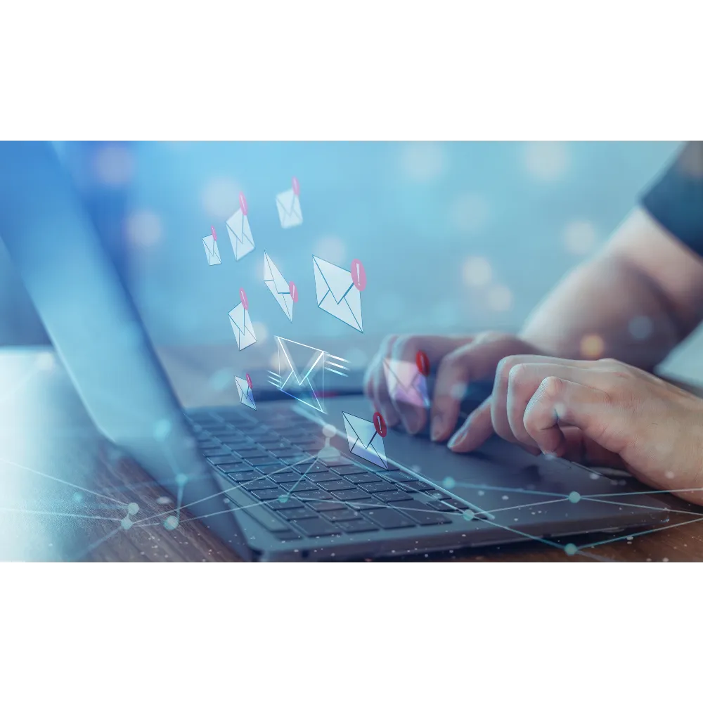 Person typing on laptop with digital envelopes and notification icons representing email communication.