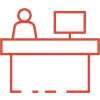 Minimalist icon of a person behind a reception desk with a computer monitor in red and white colors