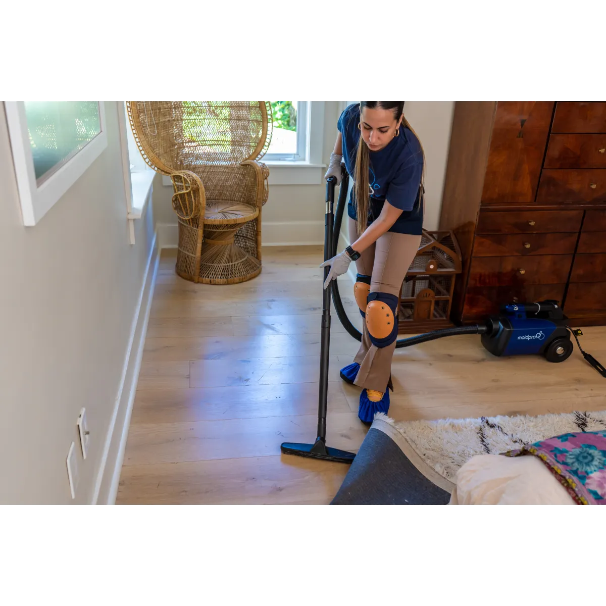 MaidPro home cleaning services cleaning and vacuuming a bedroom in South Miami, Florida