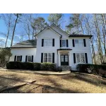 a white house with a black door