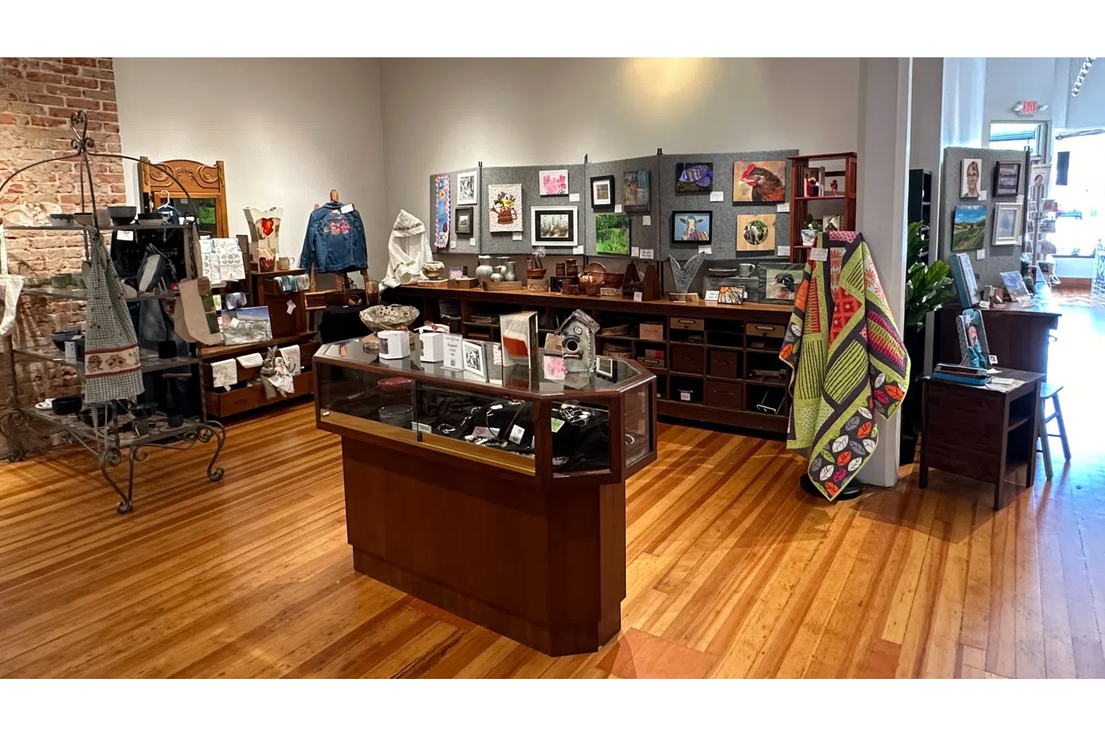 a room with a wood floor and a wood floor with a display of objects on it