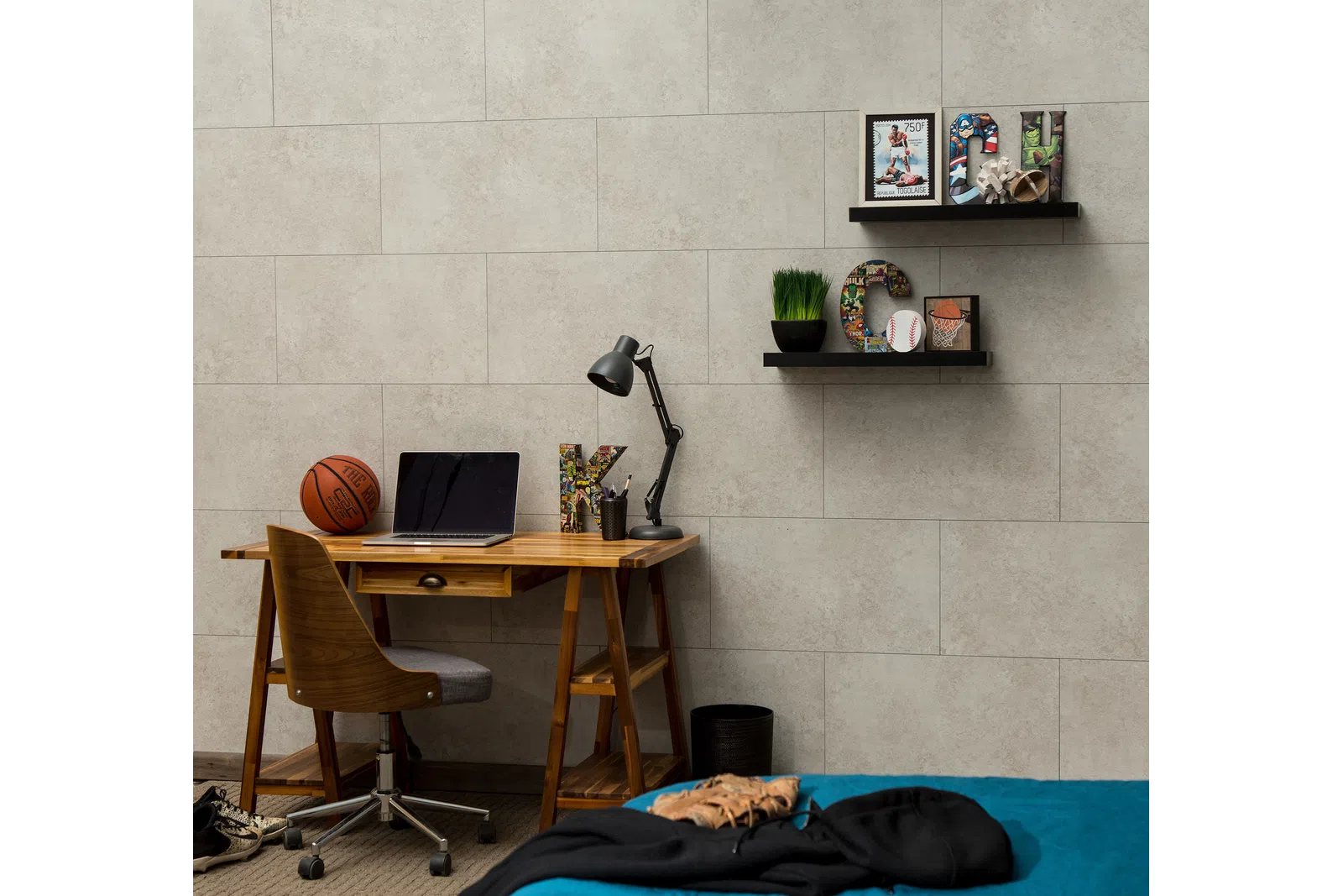 Modern bedroom workspace with wooden desk, basketball, laptop, decorative letters, and shelves with sports-themed decor.