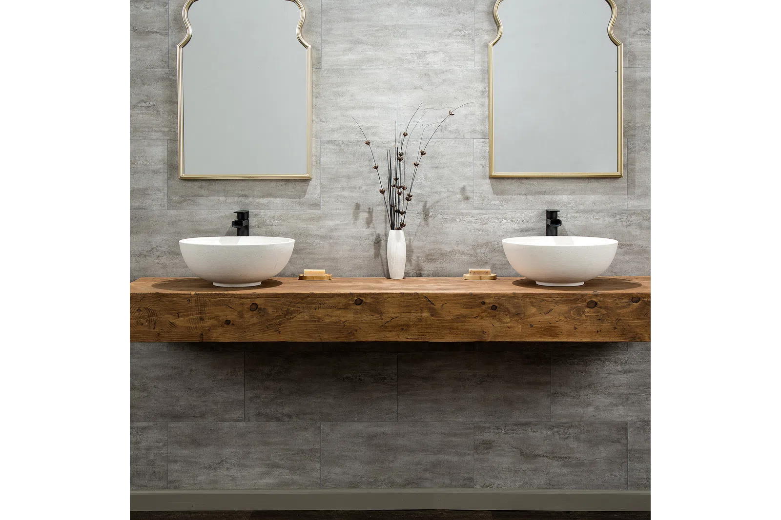Modern double bathroom vanity with white vessel sinks, wooden countertop, decorative vase, and stylish mirrors.