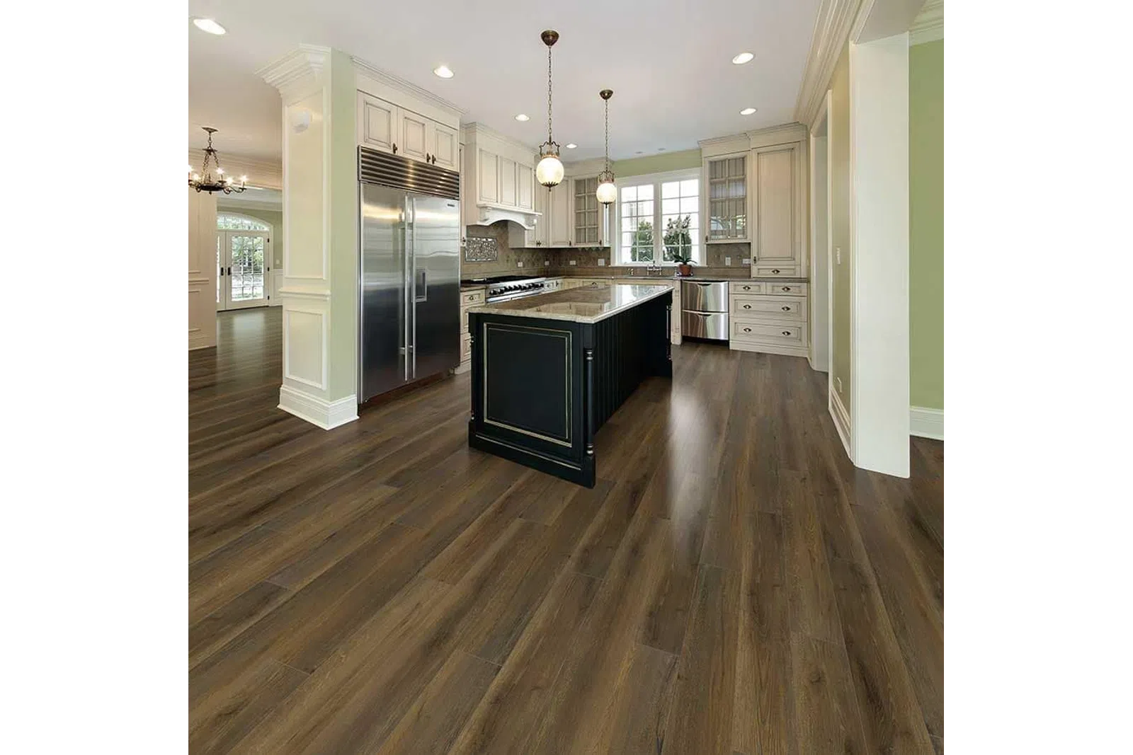Modern kitchen with dark wood flooring, black island, white cabinets, stainless steel appliances, and pendant lights.