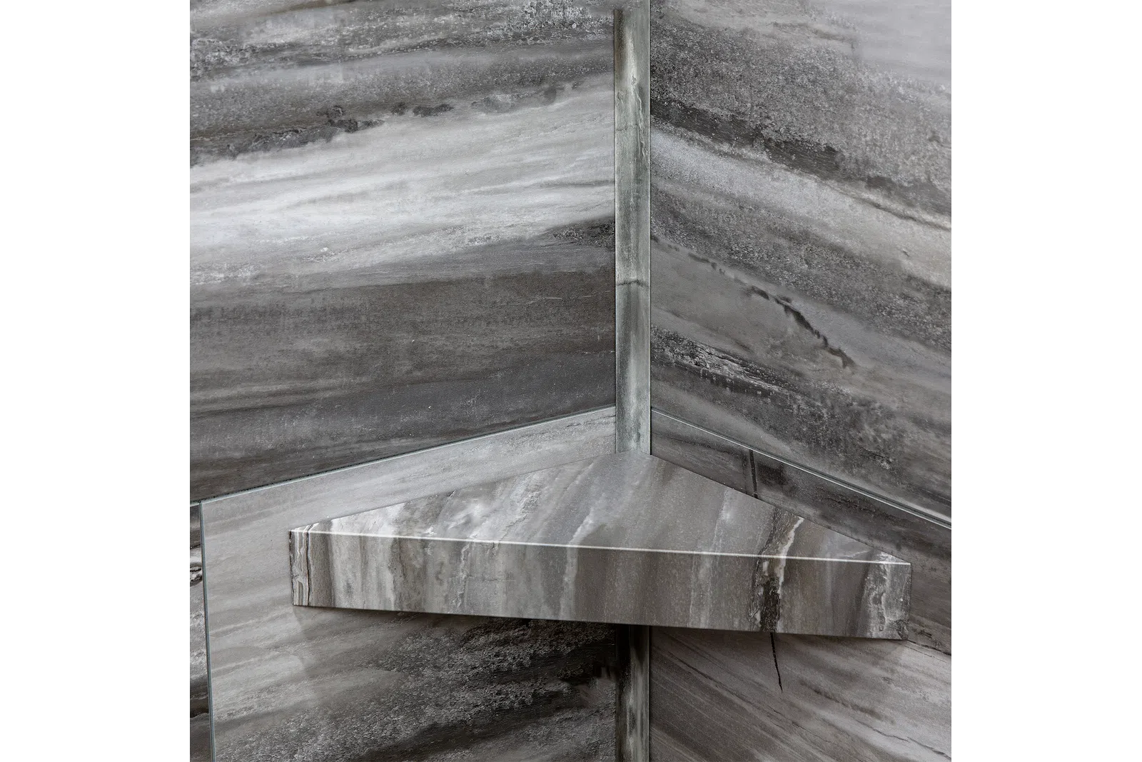 Gray marble corner shelf mounted on matching marble walls with natural stone patterns.