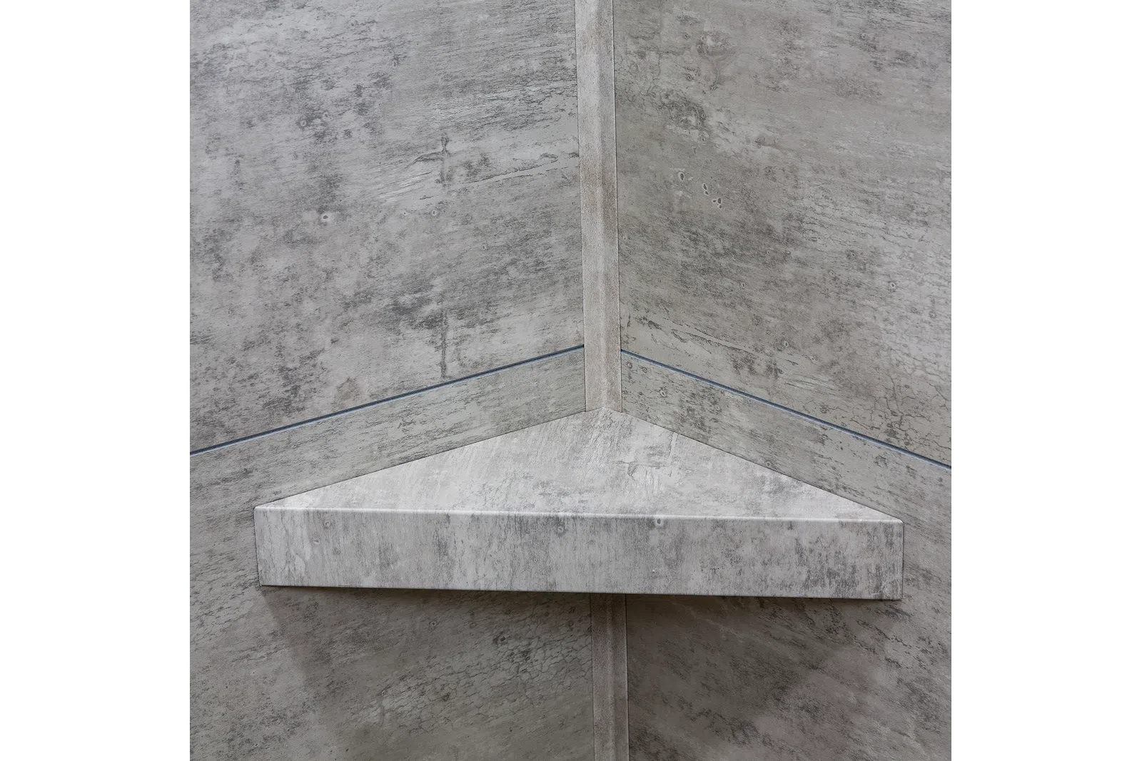 Concrete triangular floating corner shelf mounted on textured gray concrete walls in an industrial style.
