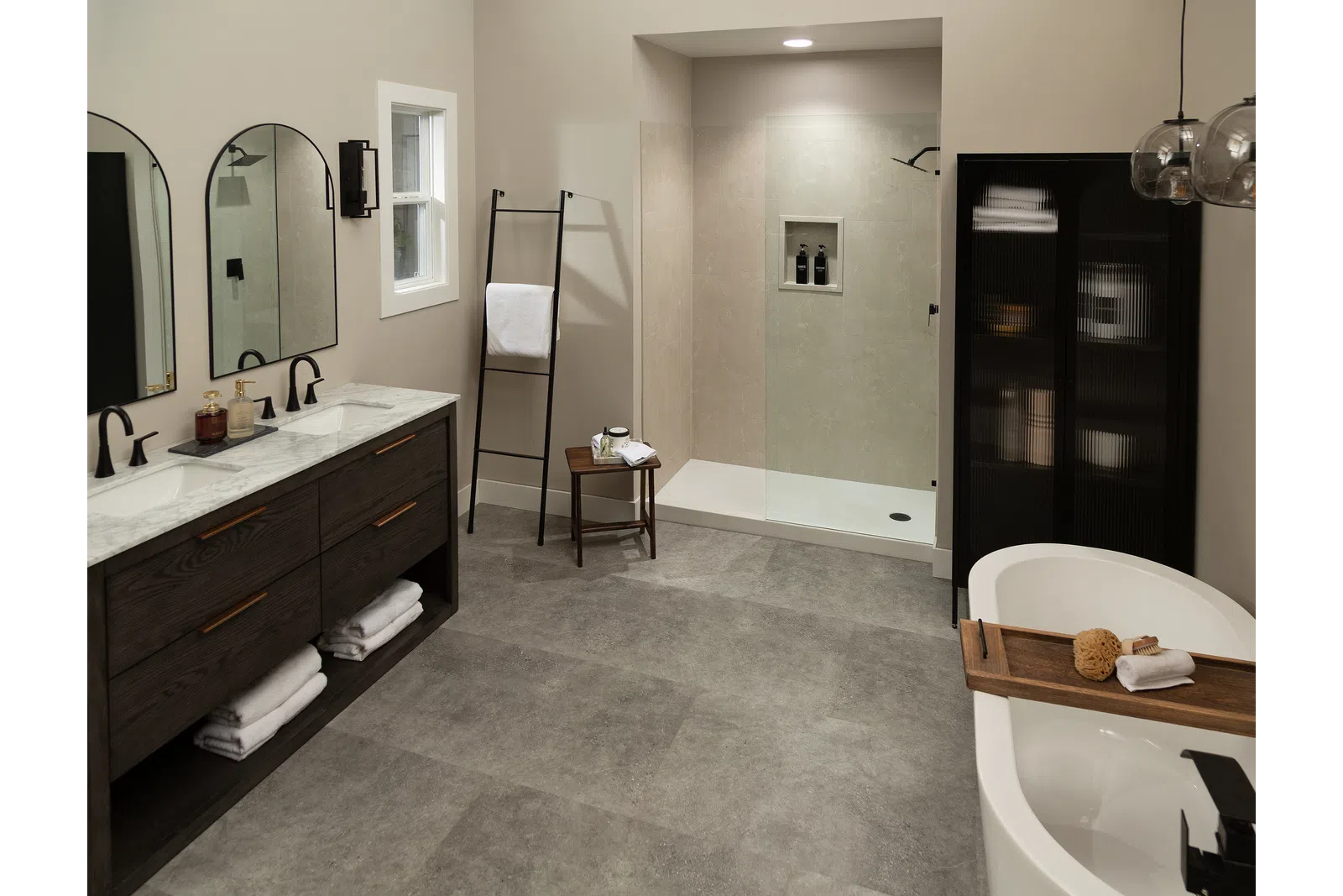 Modern bathroom with double vanity, walk-in shower, freestanding tub, and neutral tones with sleek finishes