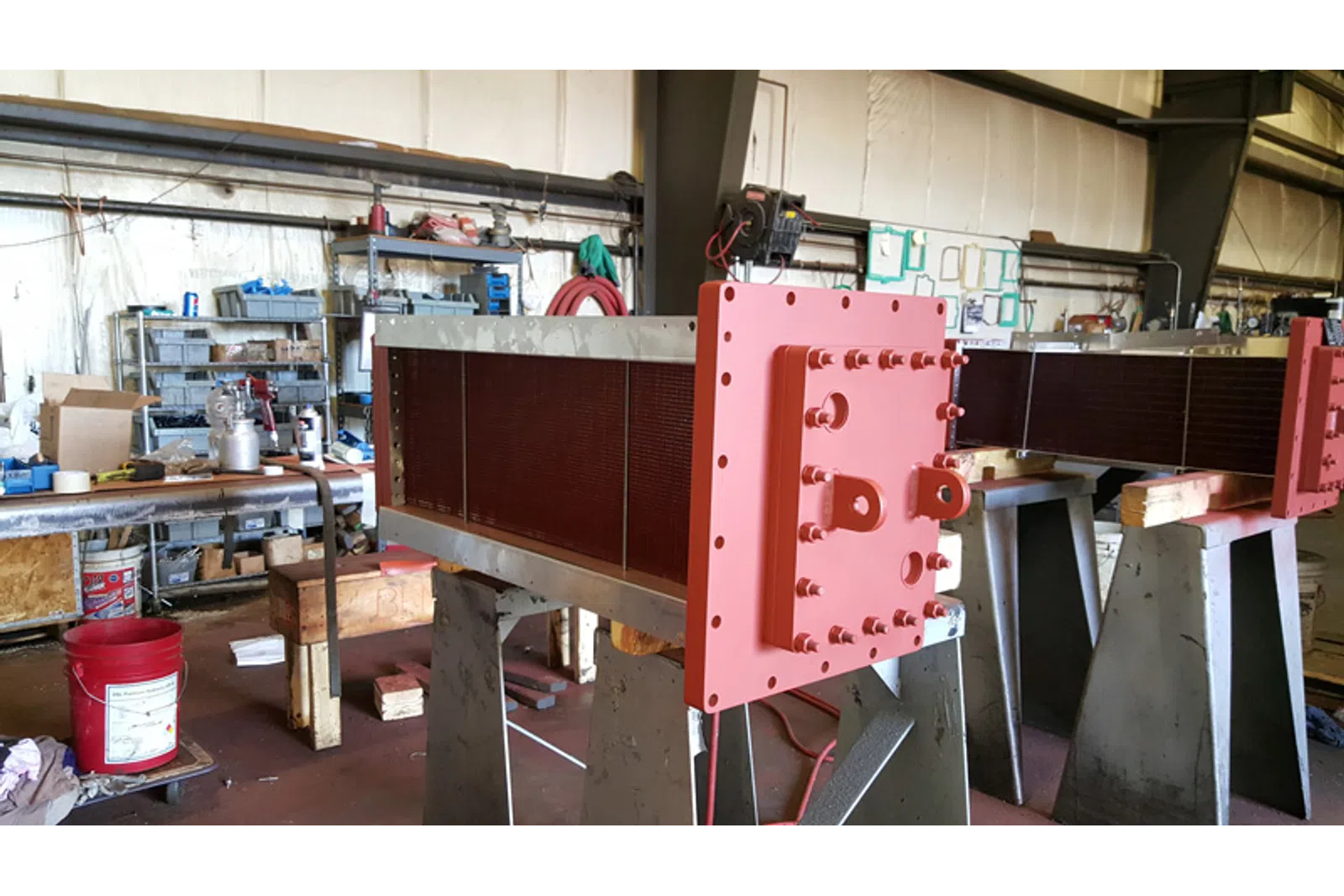 a large red machine in a factory