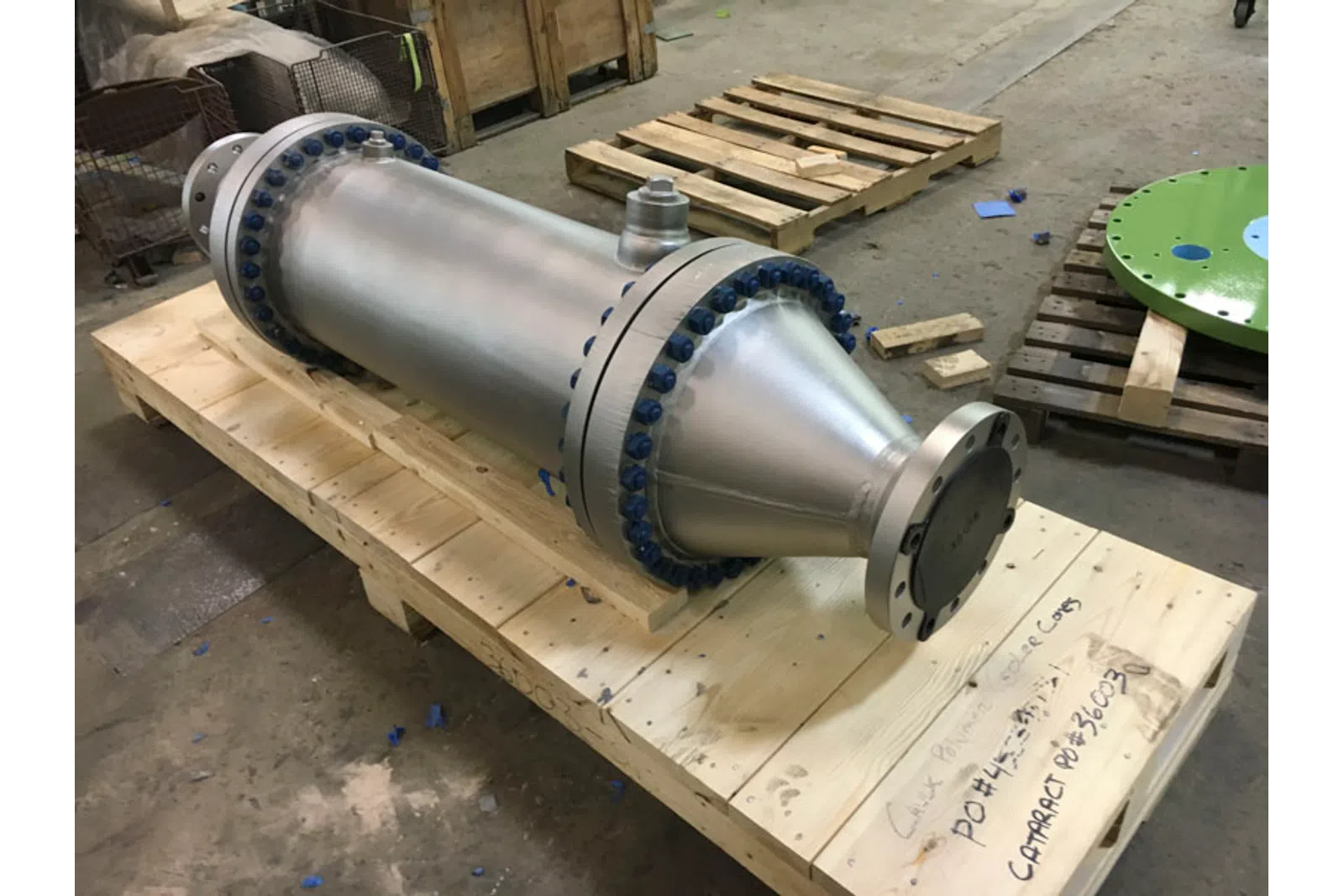 a metal pipe on a piece of wood