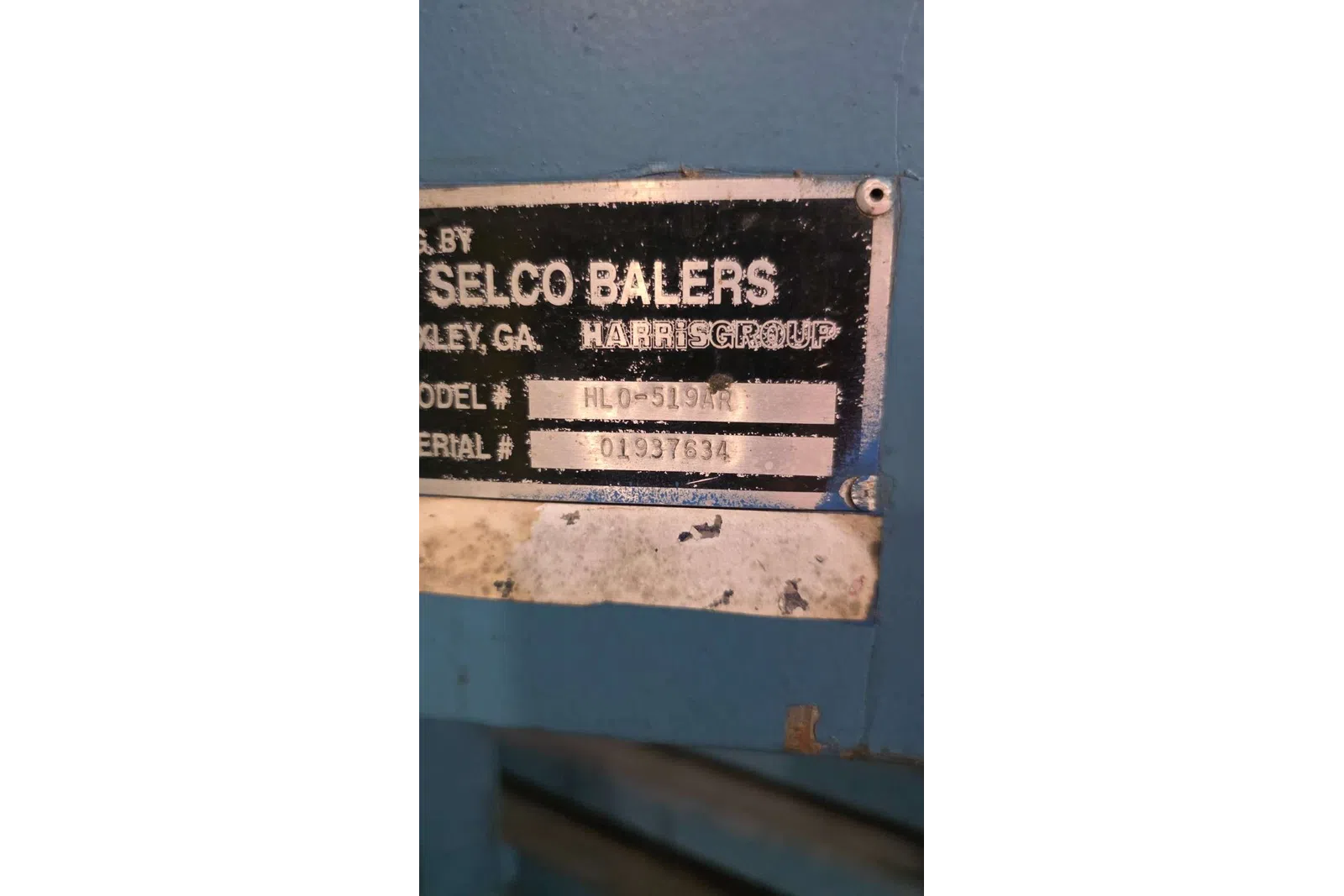 Close-up of Selco Balers metal identification plate with model HL0-519AR and serial number 01937634.