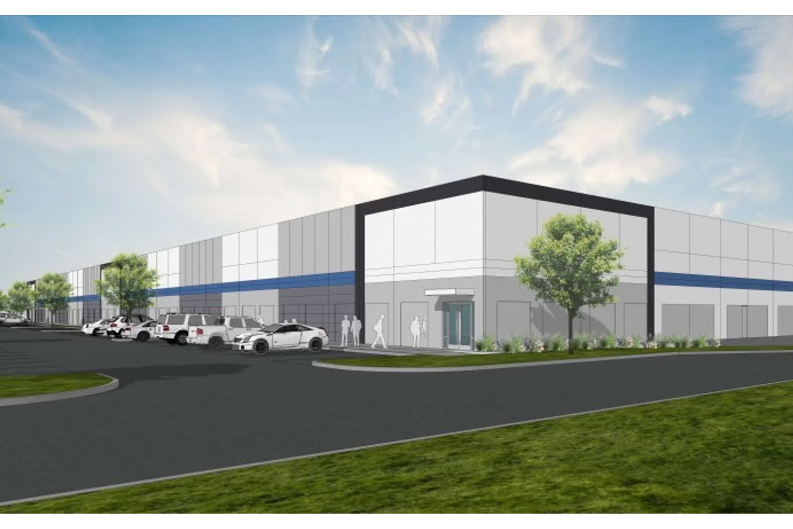 Modern warehouse building exterior with parked cars, trees, and a partly cloudy sky in the background.