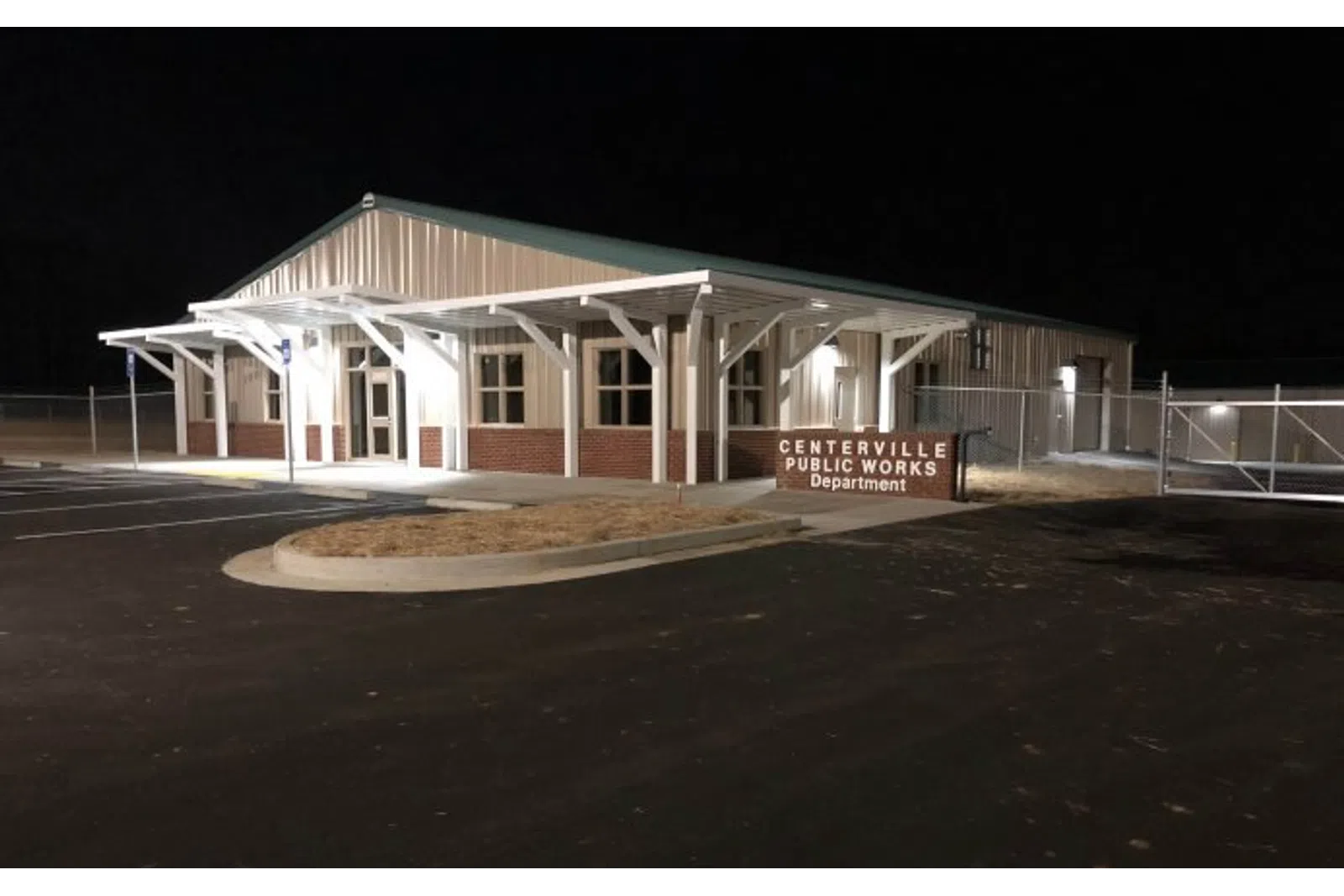 Night view of Centerville Public Works Department building with illuminated entrance and empty parking lot.