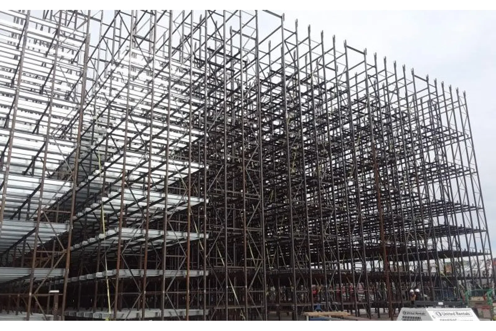 Extensive metal scaffolding structure assembled for construction with multiple interconnected levels and support beams.