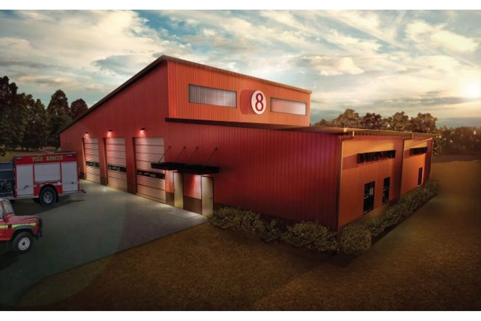 Red fire rescue station number 8 building with fire trucks parked outside during sunset.