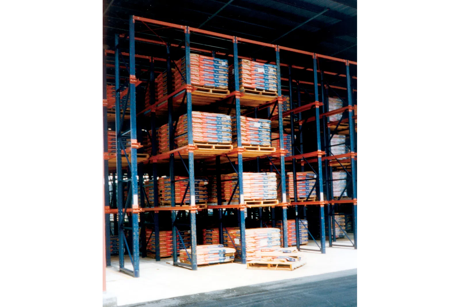 Warehouse racks filled with stacked pallets of packaged goods in an industrial storage facility.