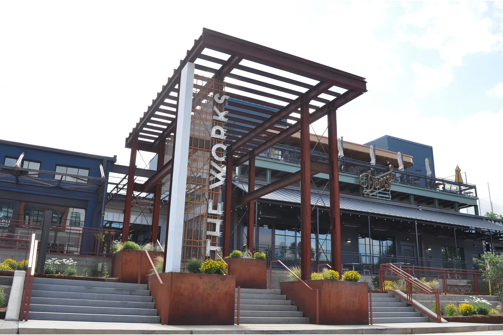Exterior view of The Works building with modern architecture and outdoor staircases under clear sky