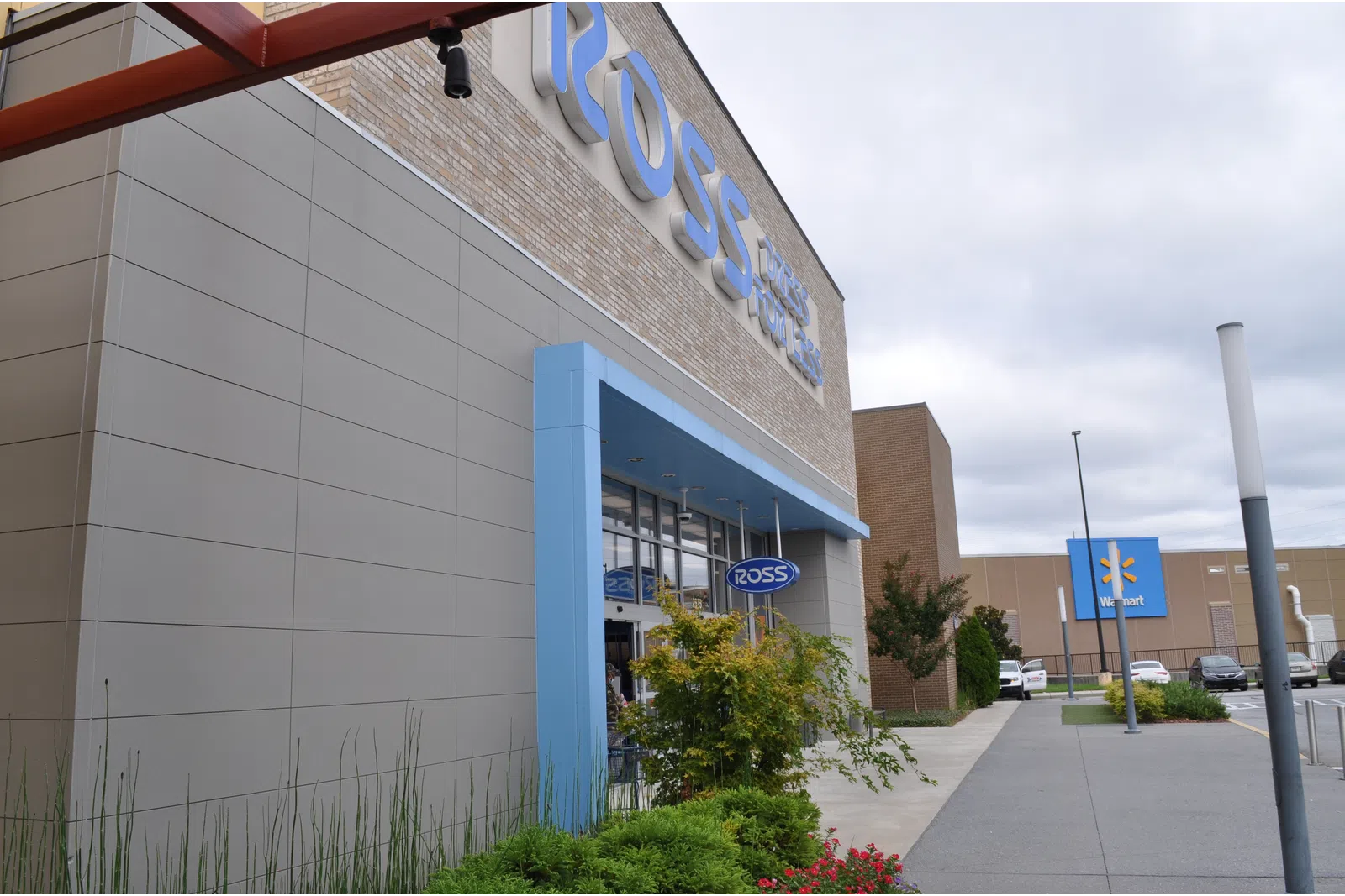 Exterior view of a Ross Dress for Less store with Walmart in the background on a cloudy day