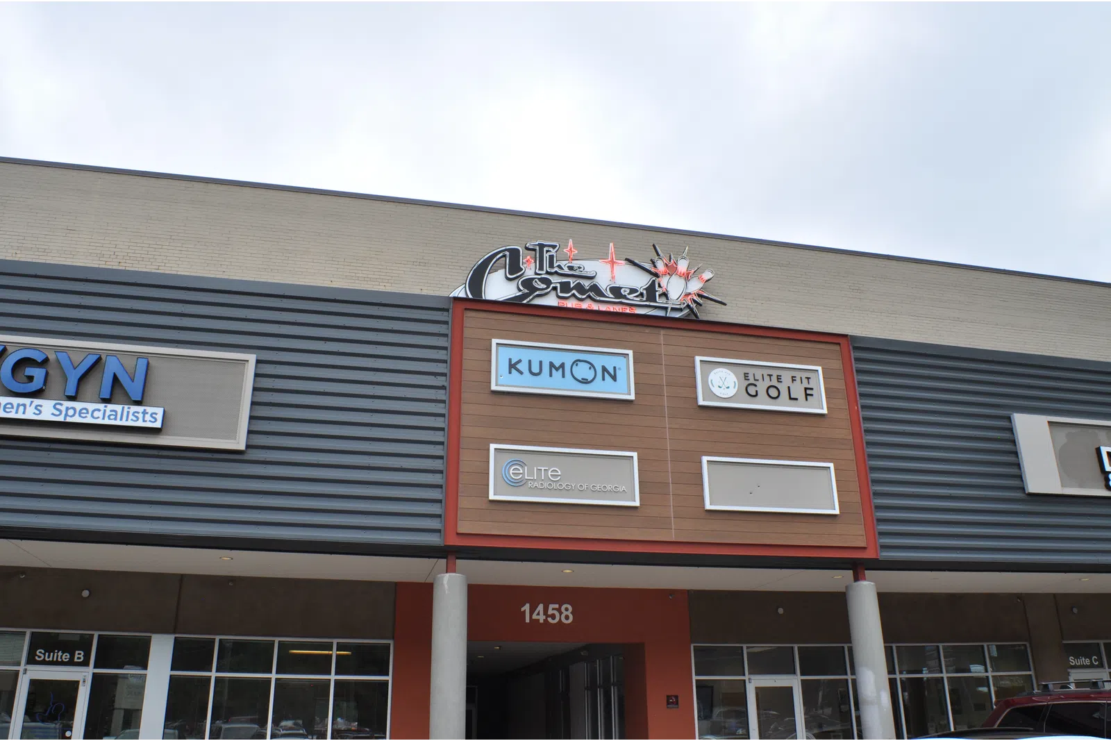 Shopping center facade with signs for Kumon, Elite Fit Golf, and Elite Physical Therapy above entrance 1458.