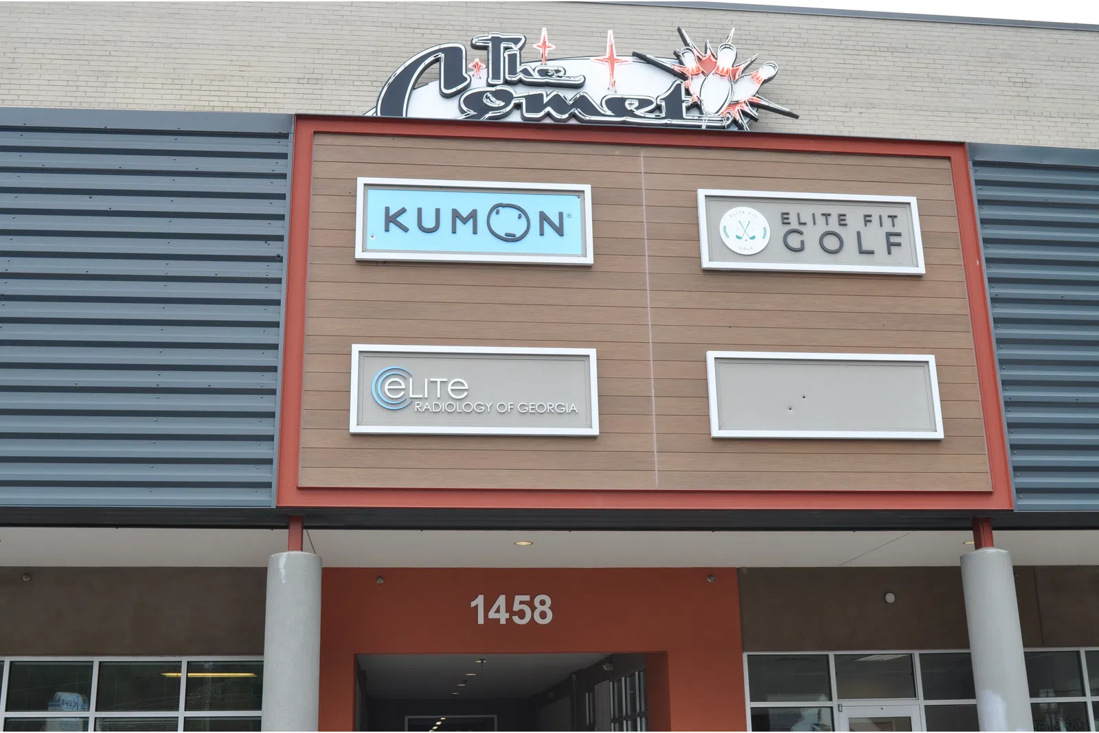 Storefront signs for Kumon, Elite Fit Golf, and Elite Radiology of Georgia on a building facade with address 1458