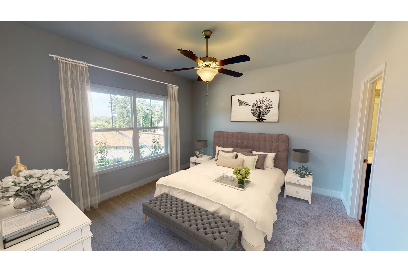 a living room filled with furniture and a large window
