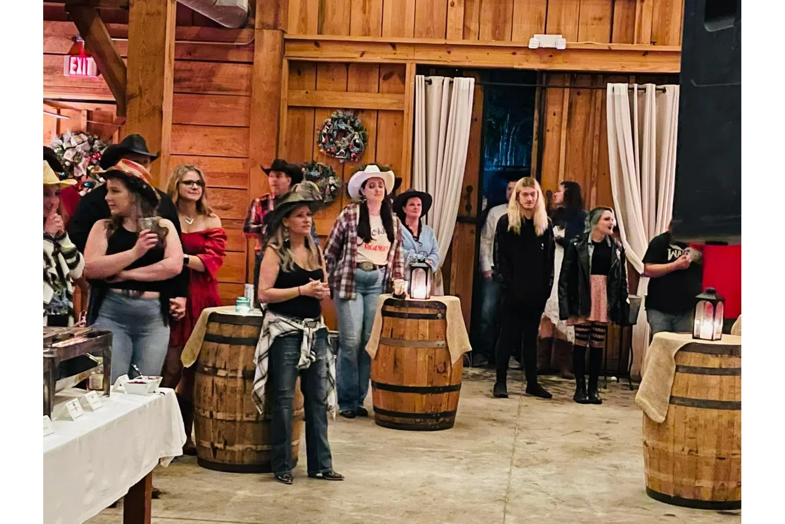 a group of people standing around barrels