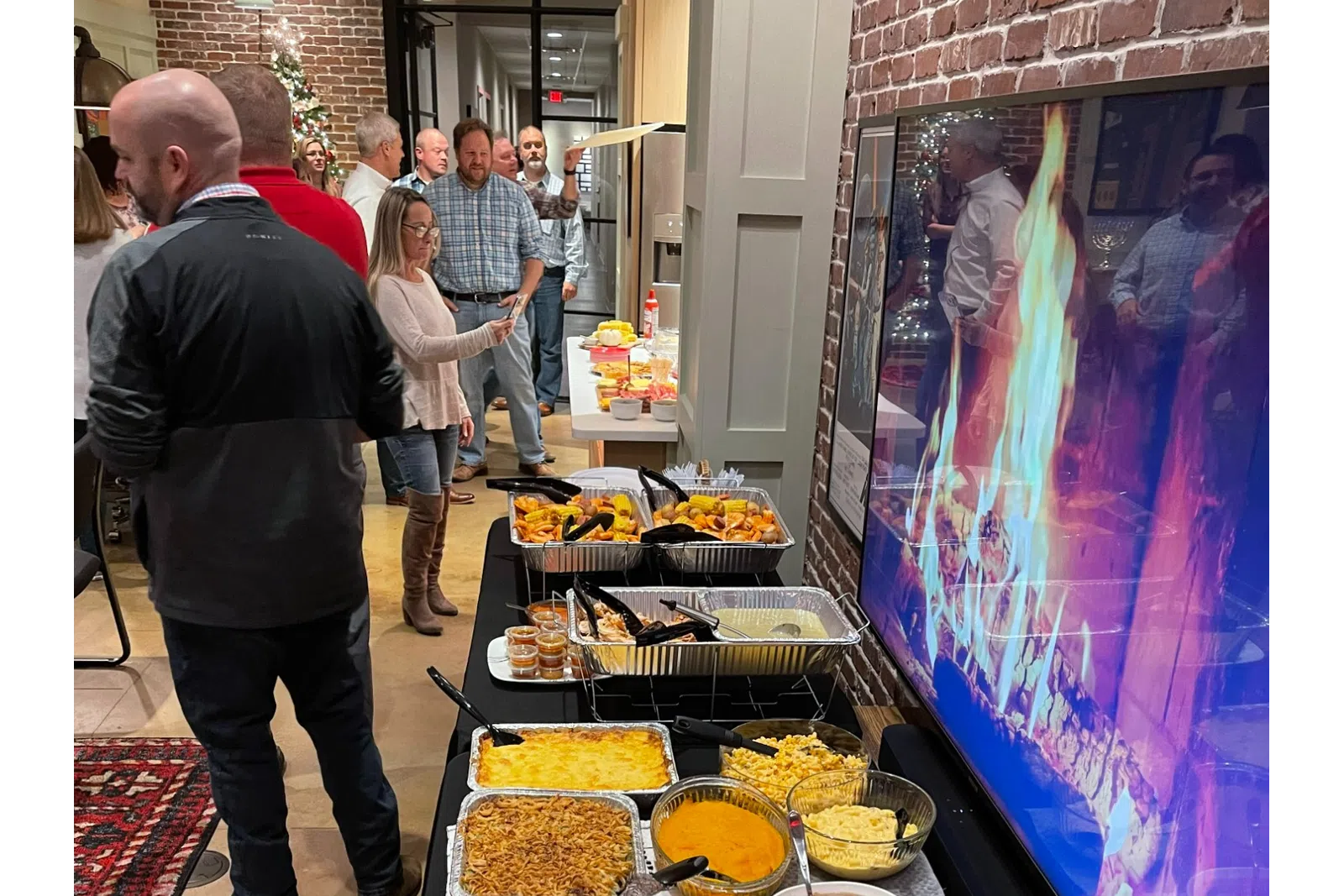 a group of people sitting at a table with food on it