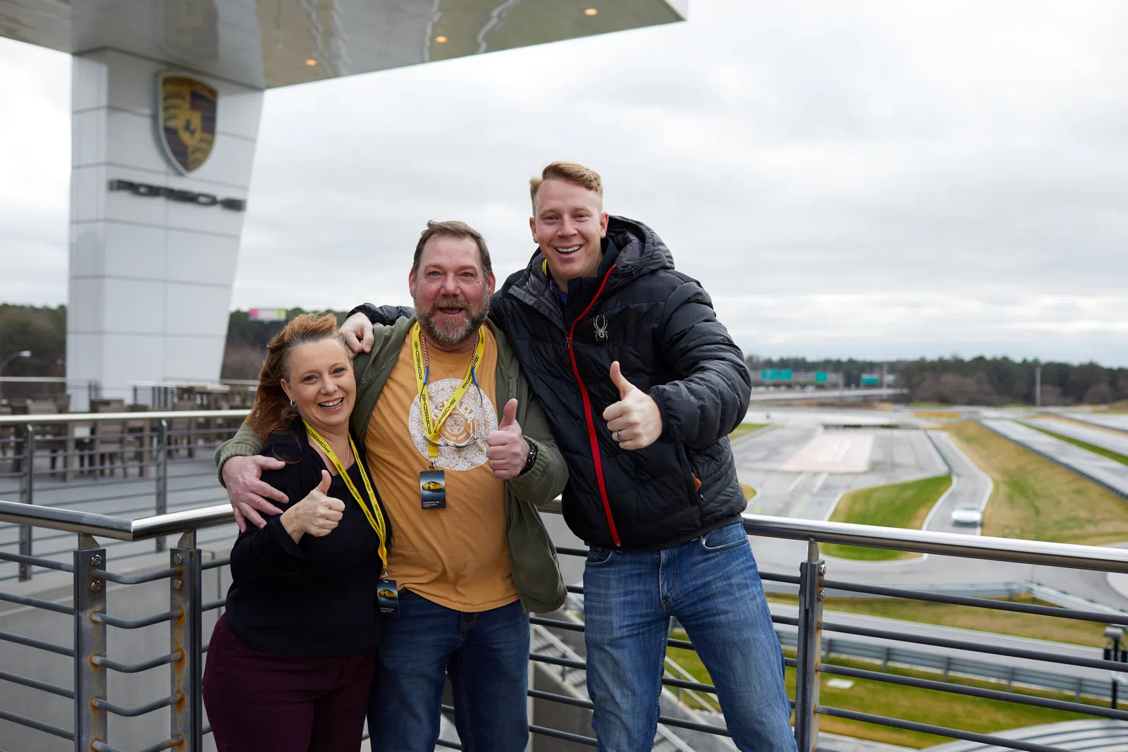 a group of people posing for a photo on a bridge