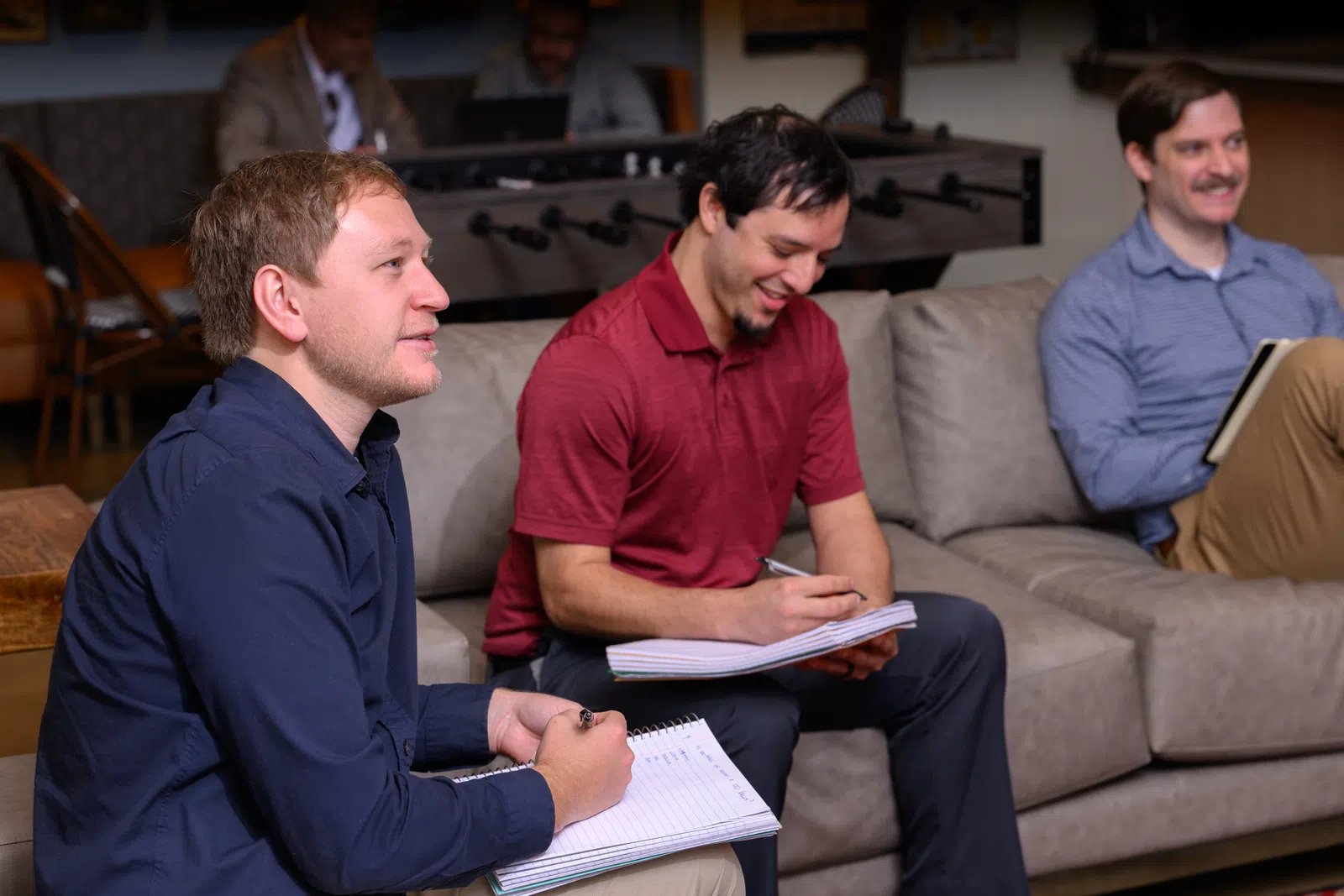 a group of men sitting on a couch