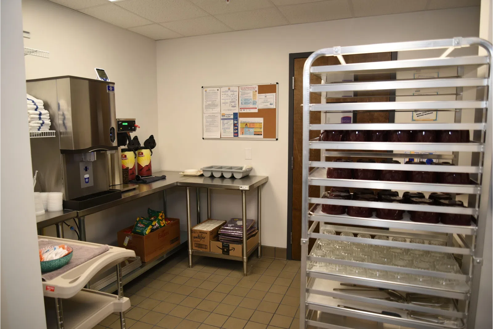 a kitchen with a table and shelves