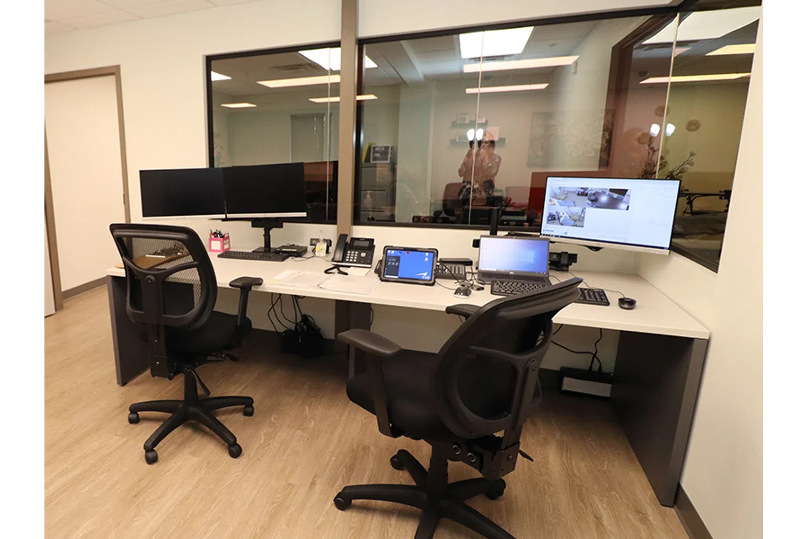 a desk with a chair and computers