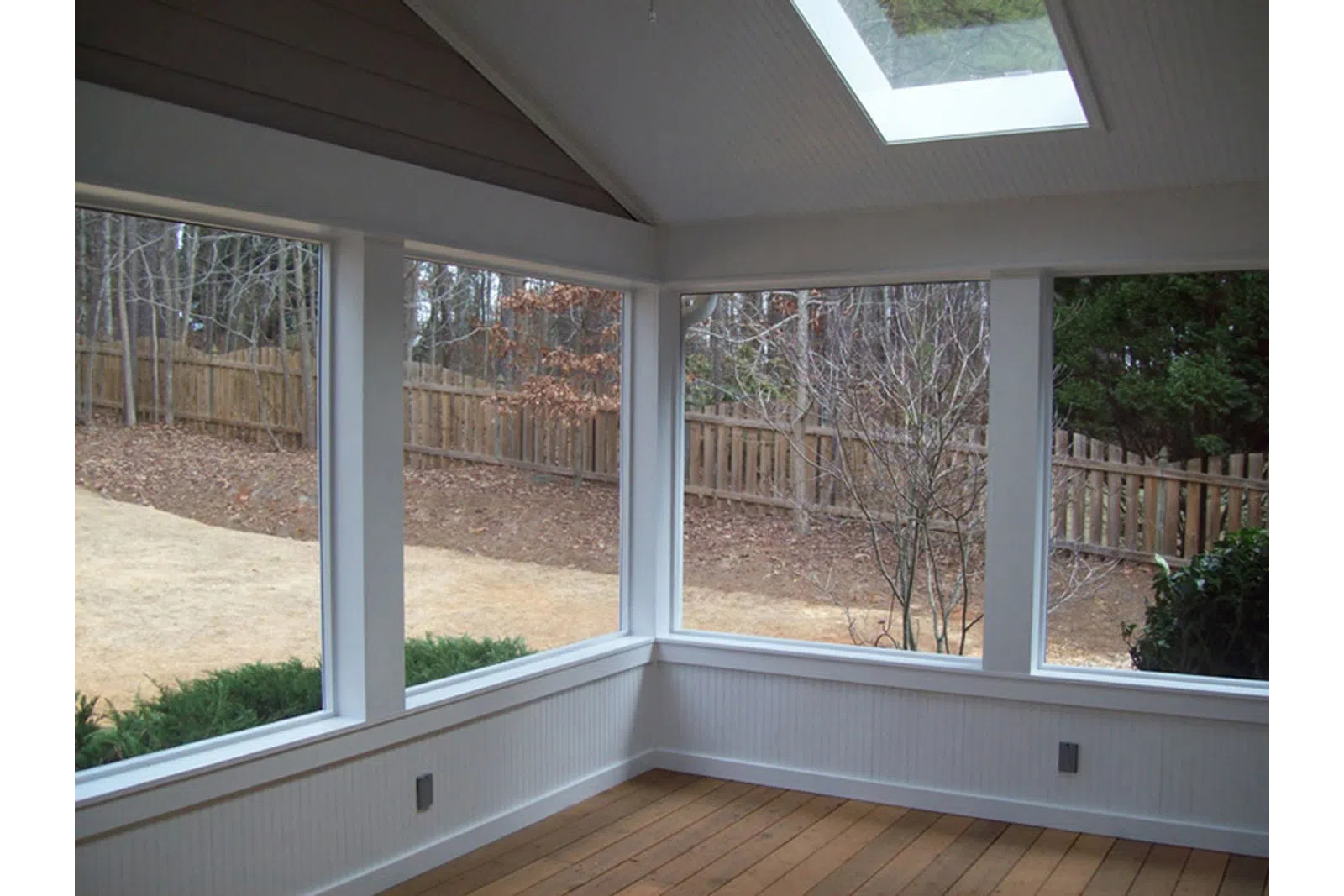 a view of a deck with a view of trees and a building