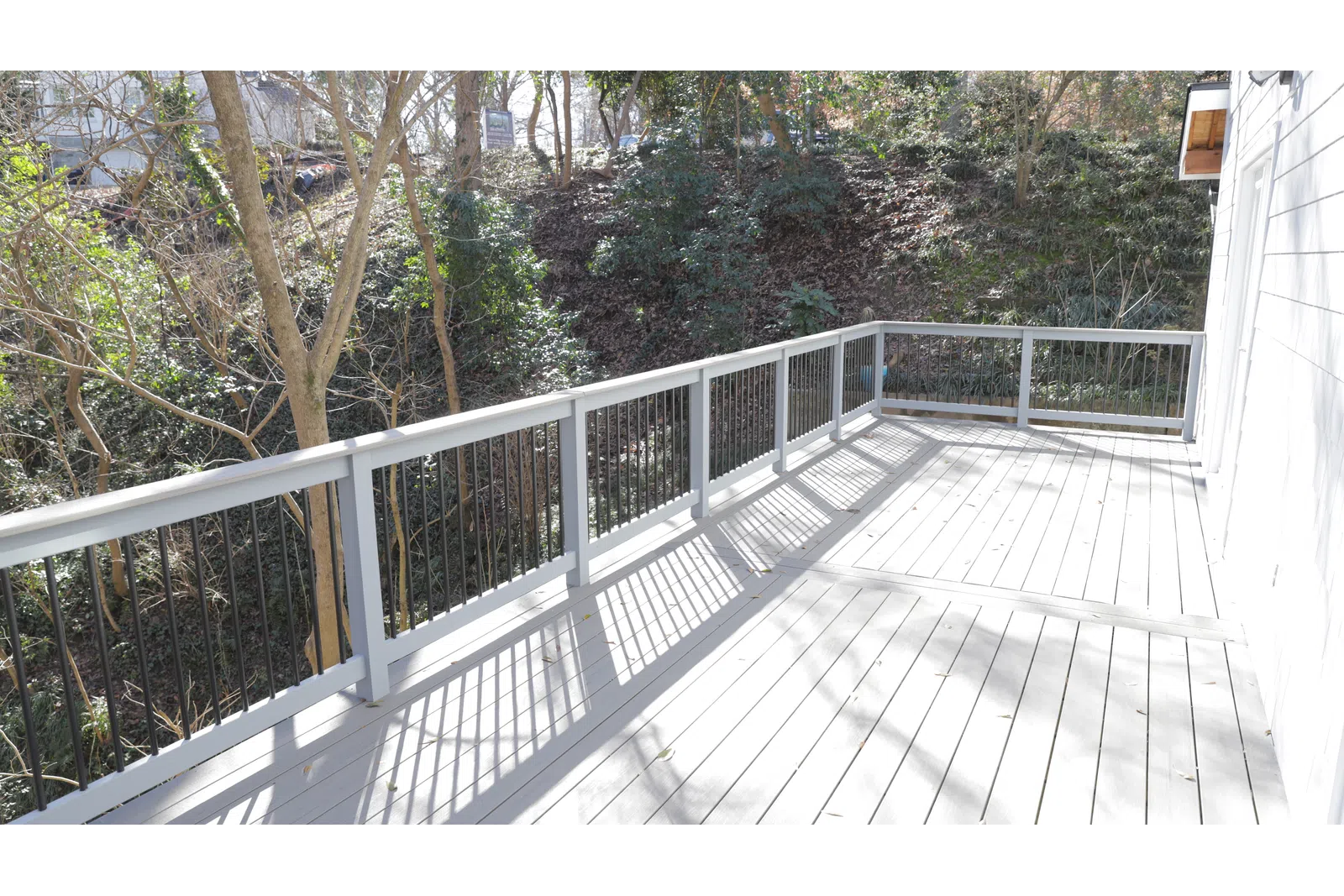 a wooden deck with trees on the side
