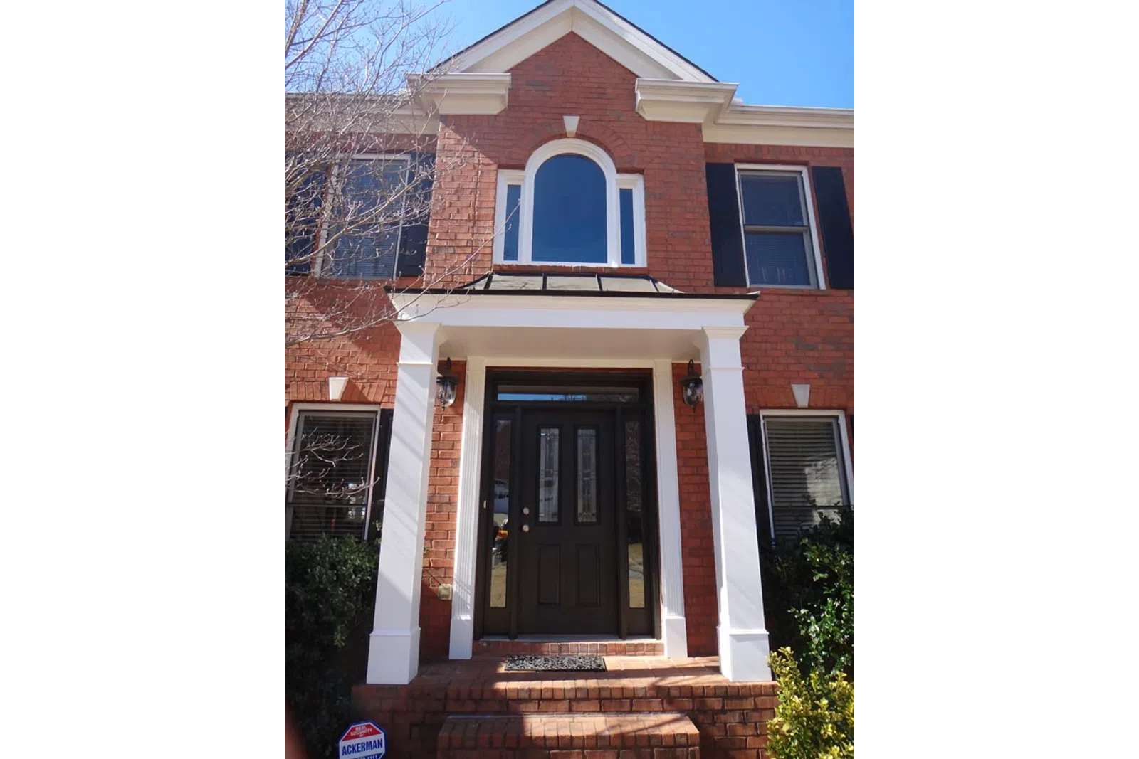 a brick building with a black door