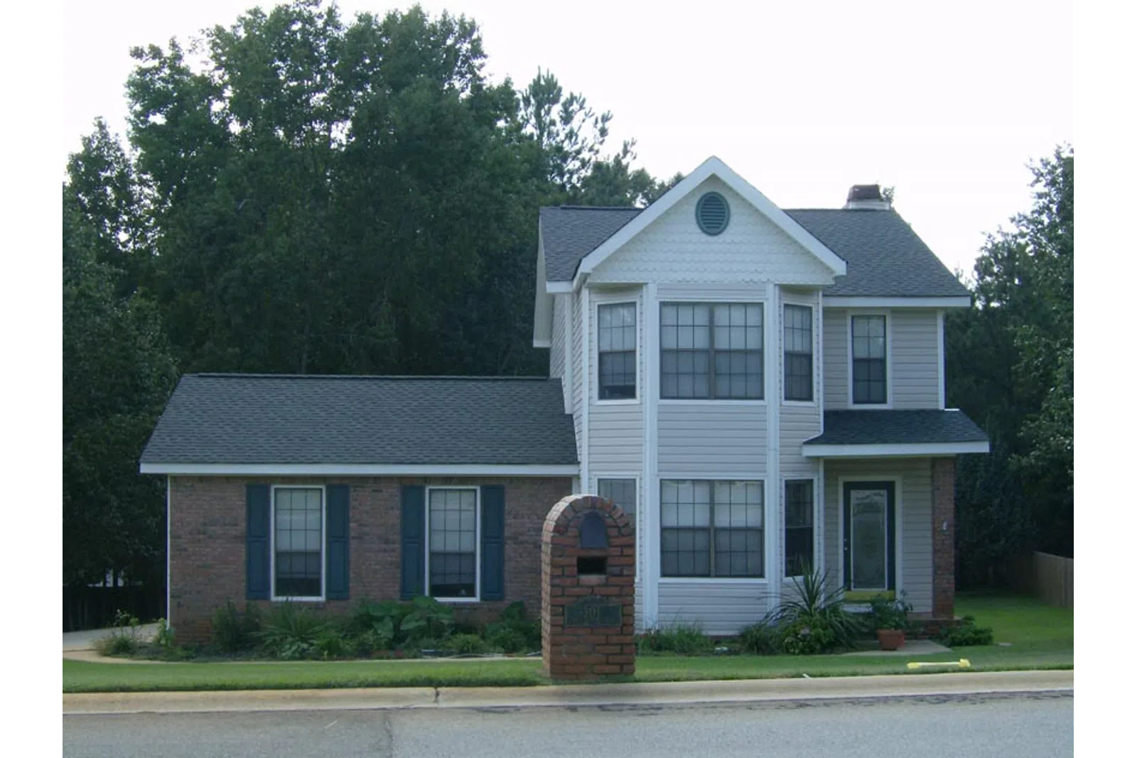 a large house with a brick driveway