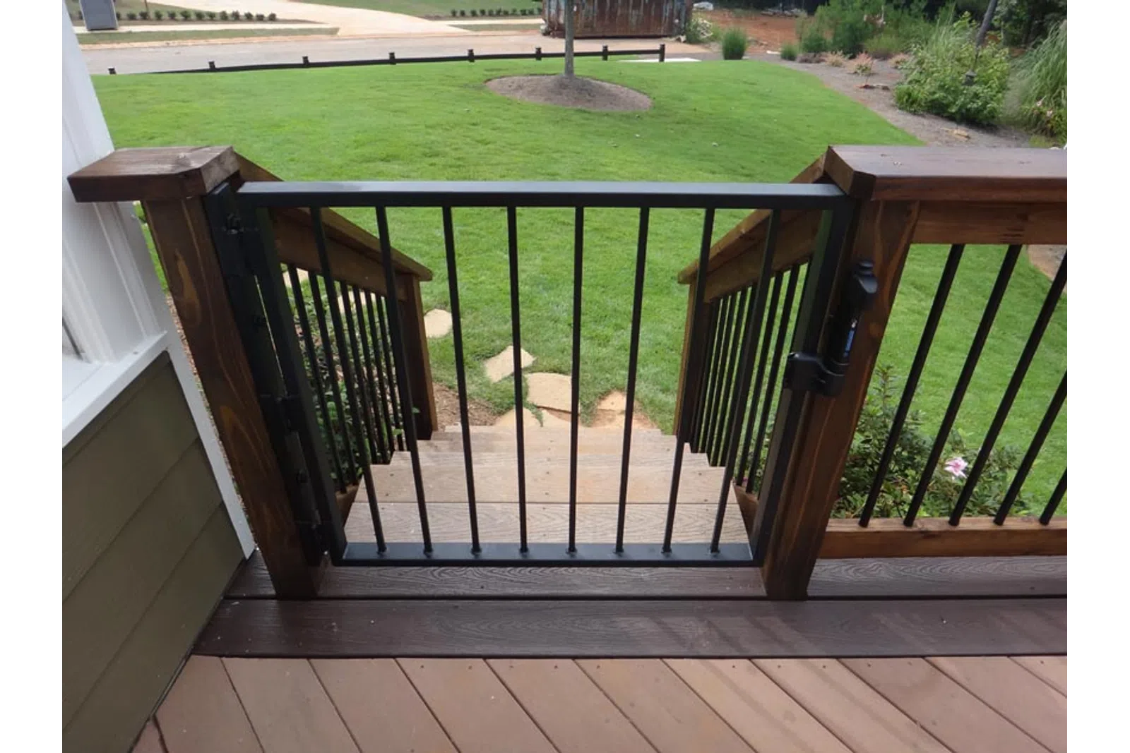 a deck with a railing and grass