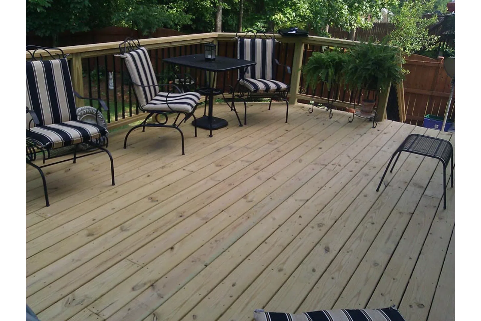 a deck with chairs and a table
