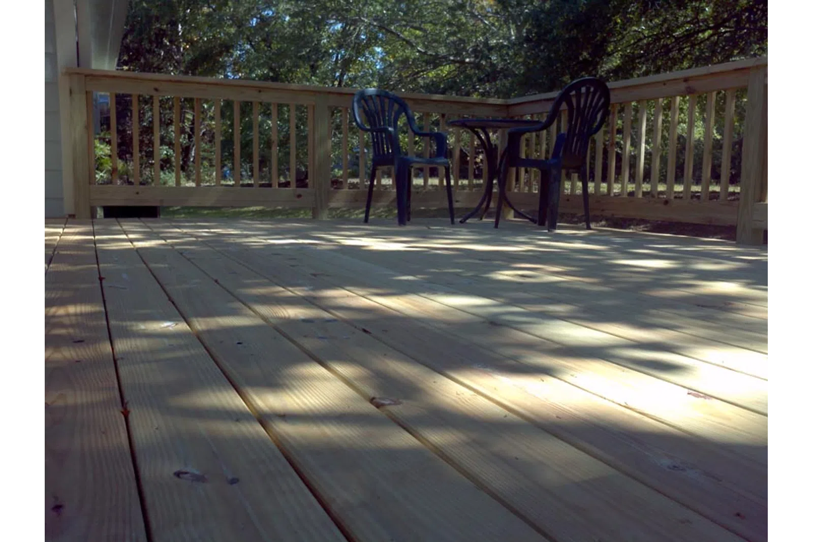 a deck with chairs and a table