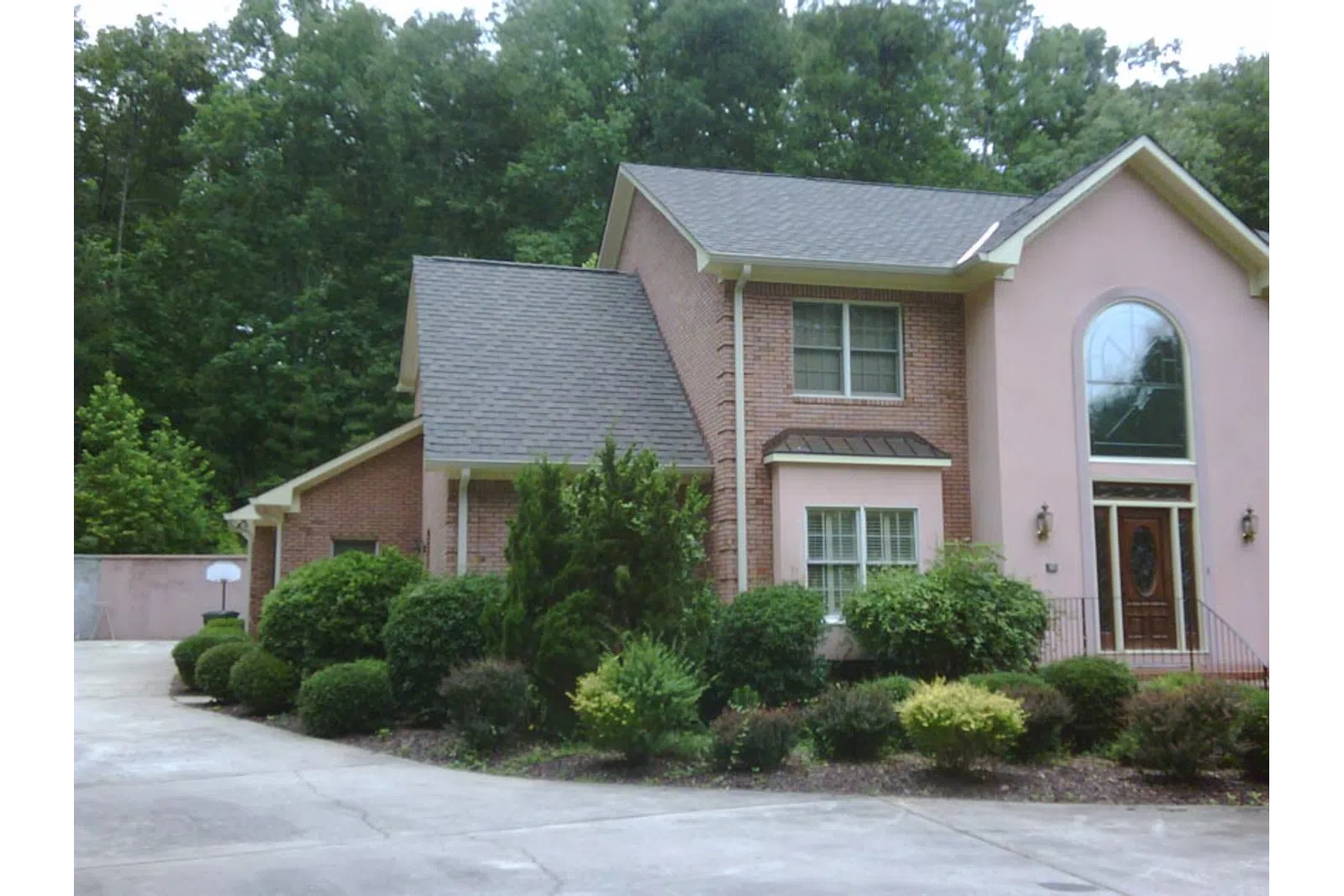 a house with bushes in front of it
