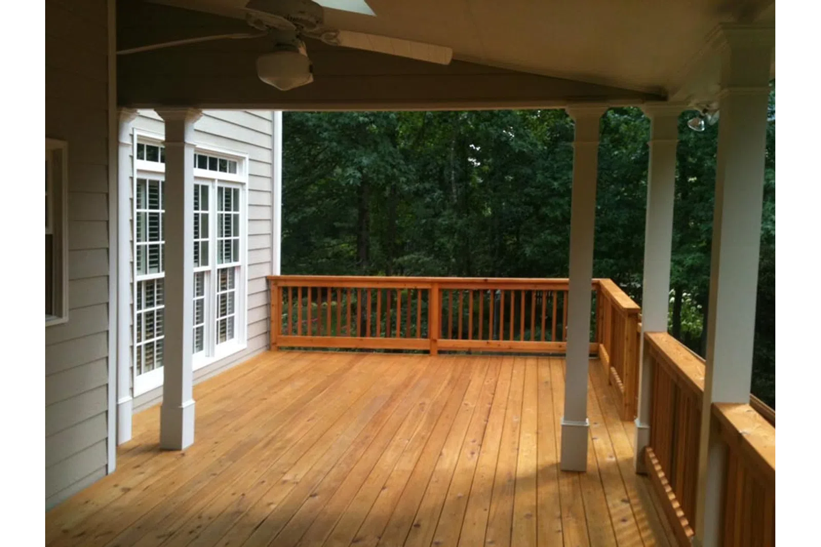 a wooden deck with a railing and a wood railing