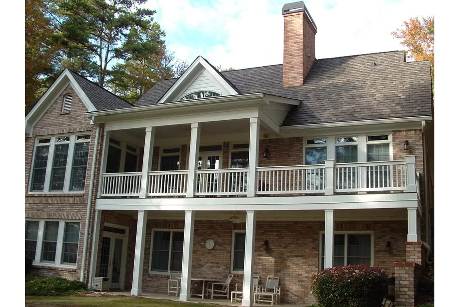 a large brick house with a white porch