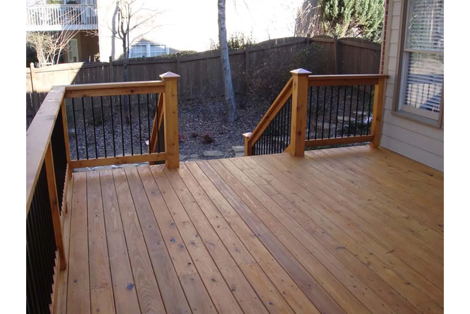 a deck with a wood railing