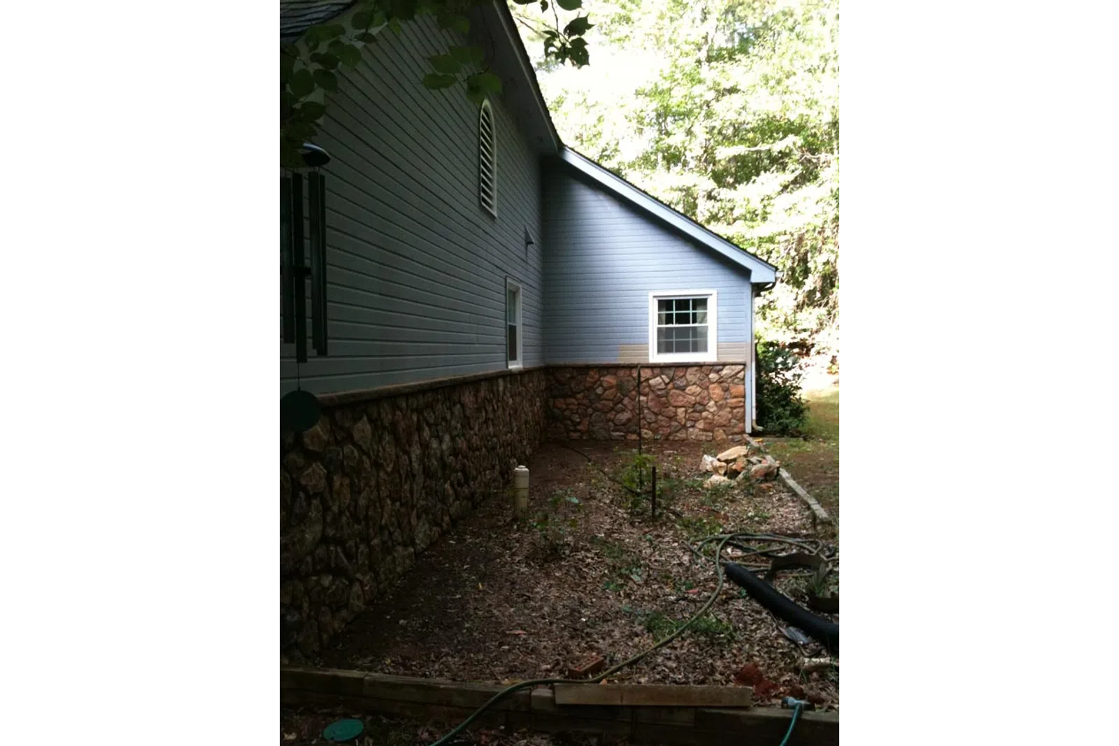 a house with a brick wall and a brick wall