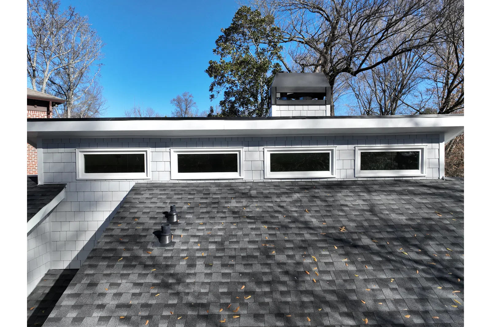 a white building with a black roof