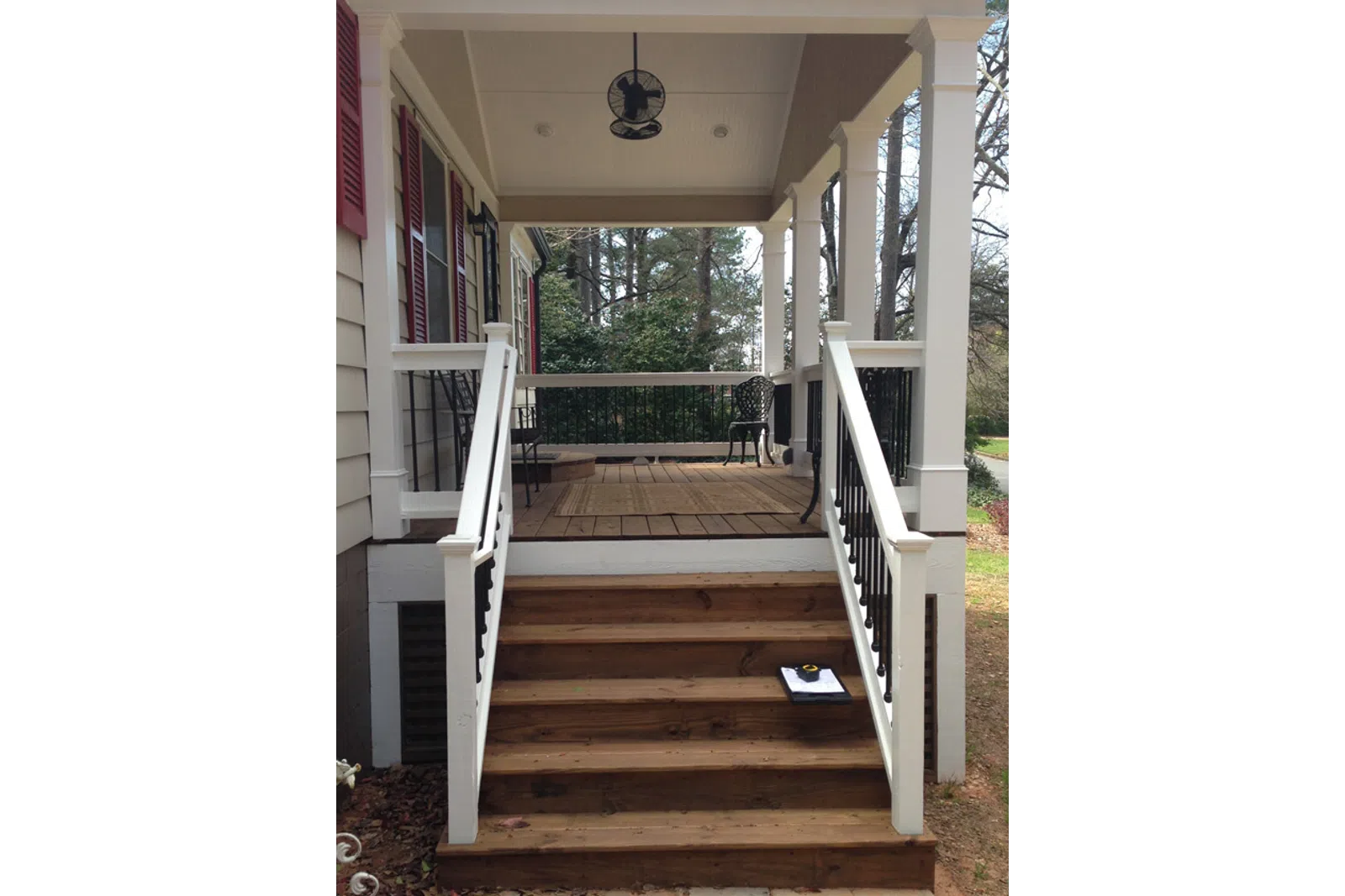 a wooden porch with a railing