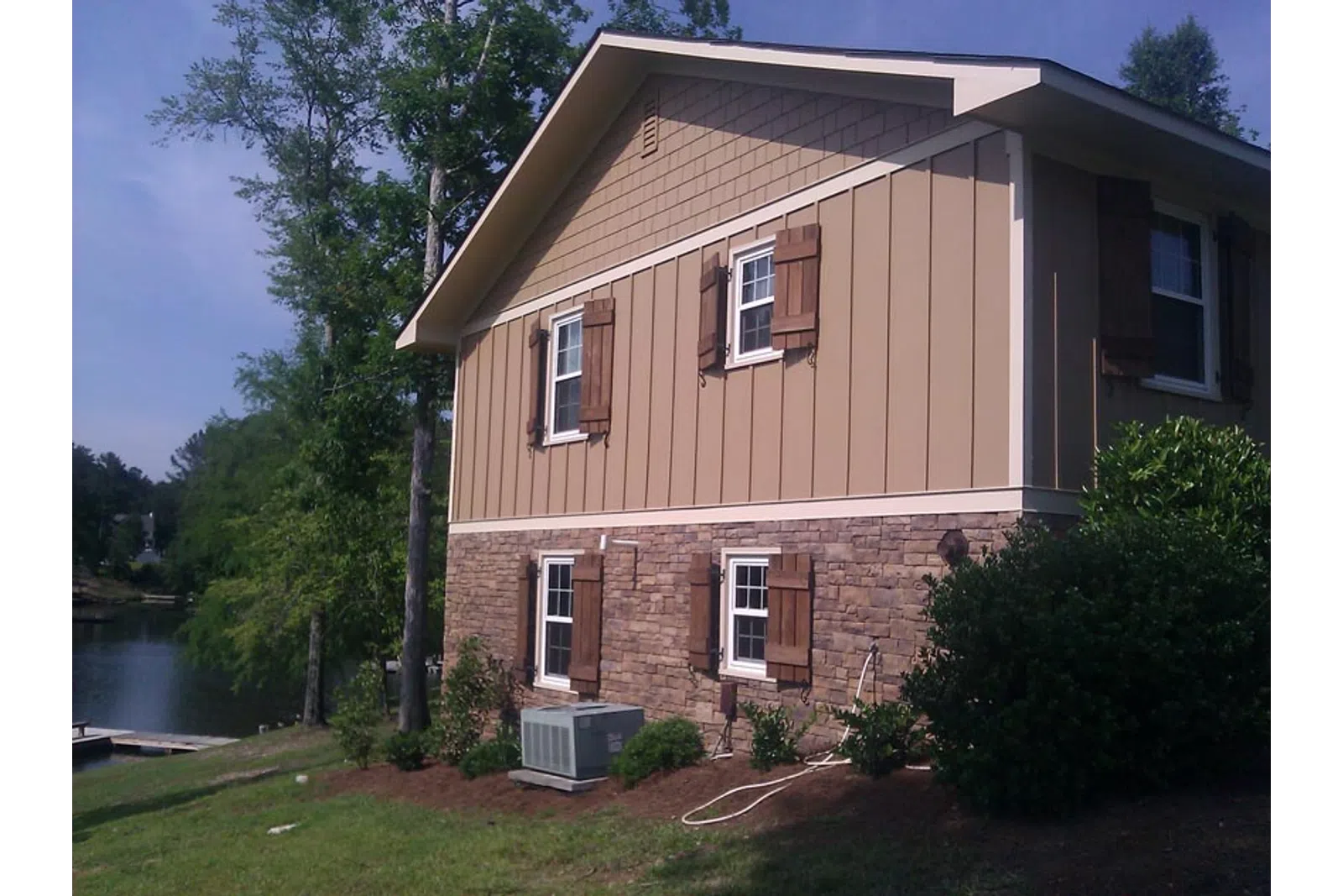 a brick house with a pond in the front