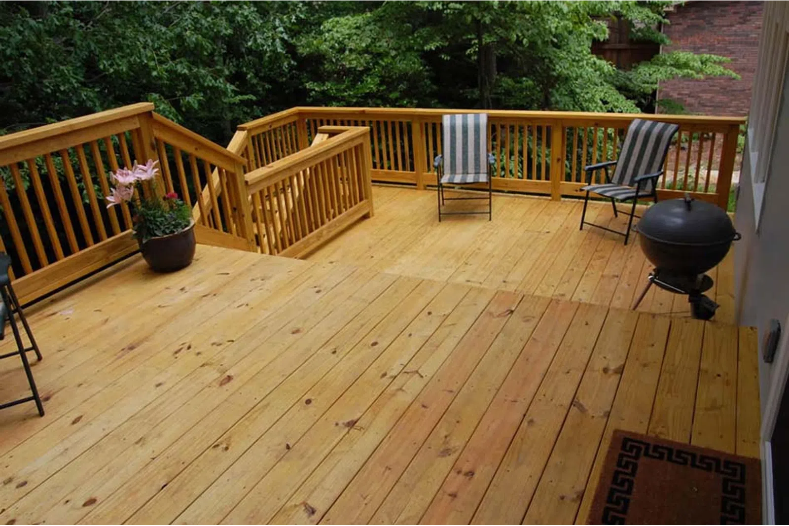 a deck with chairs and a table