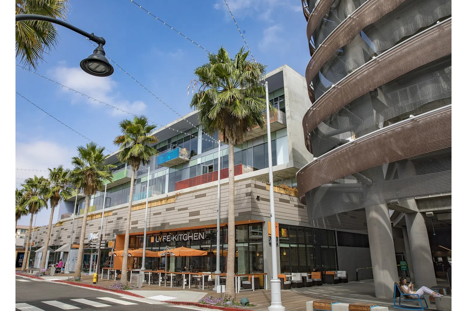 a building with palm trees and a street