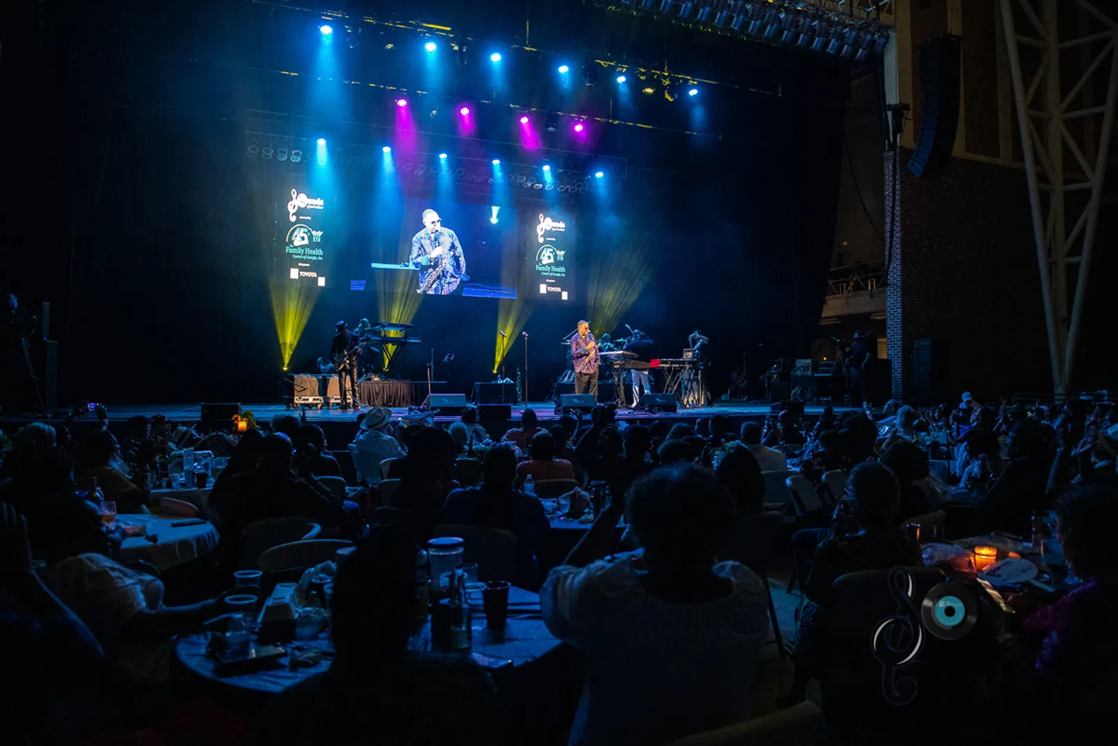 a group of people on a stage in front of a crowd