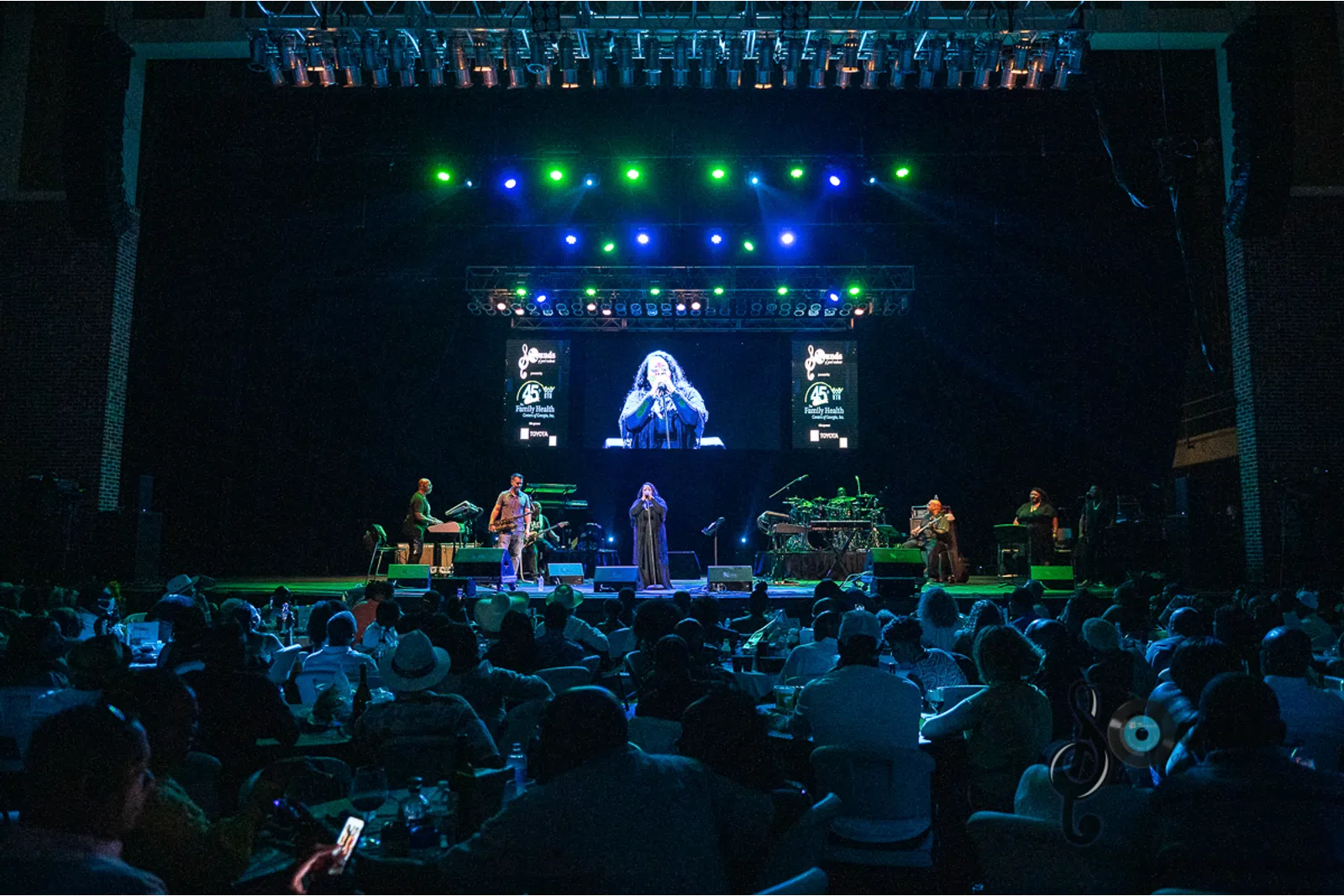 a group of people on a stage in front of a crowd