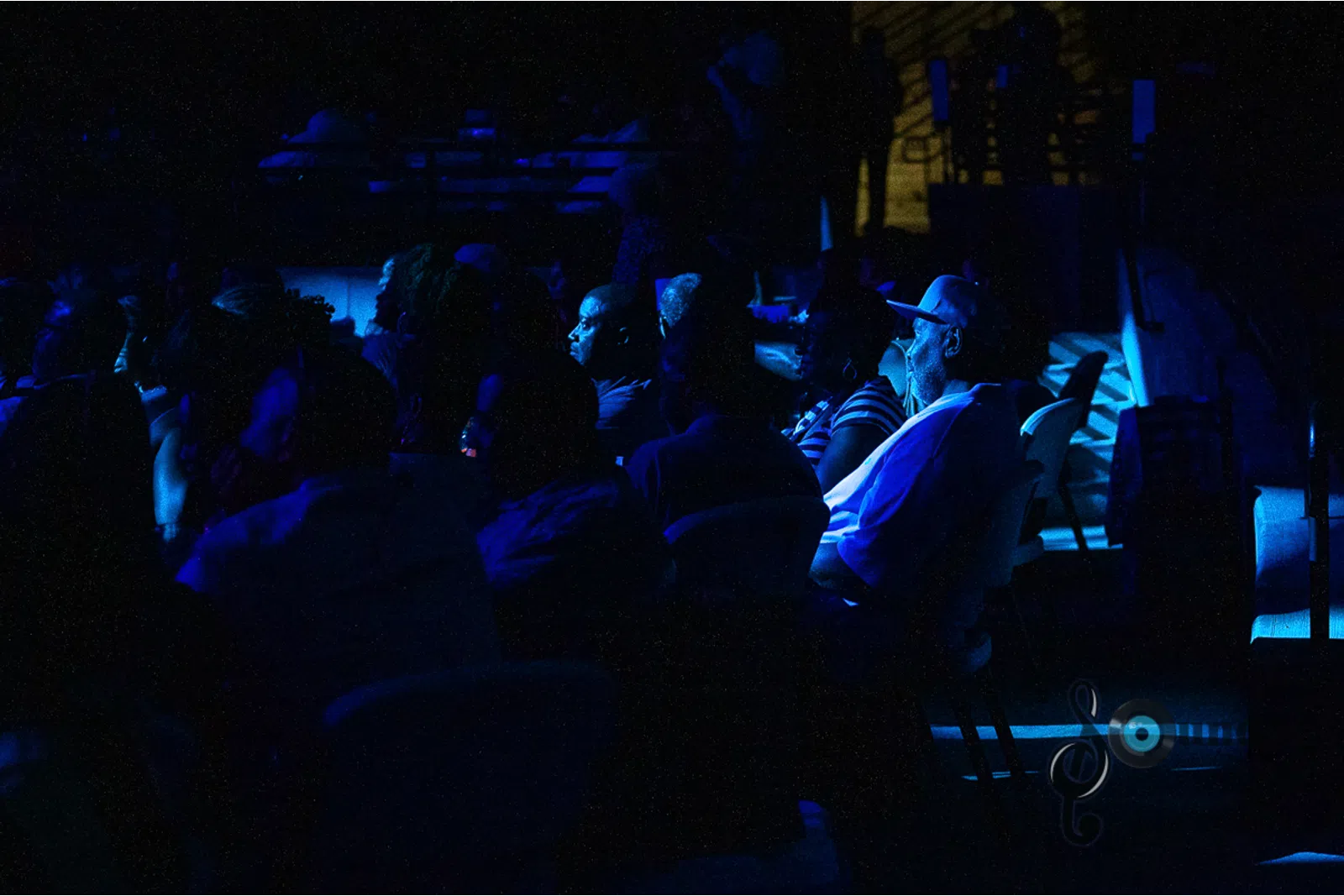 a crowd of people in a dark room